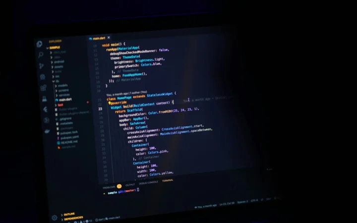 Dark laptop screen with code, representing an AI tool stack for developers