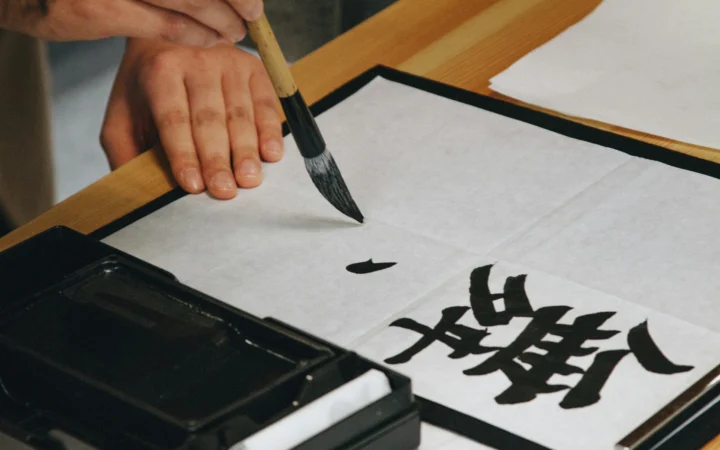 Calligraphy brush dipped in black ink, the core of an AI calligraphy generator's target style