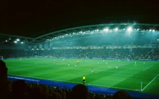 Football stadium floodlights lighting a pitch at night, linked to the Alexia Putellas Ballon d'Or story