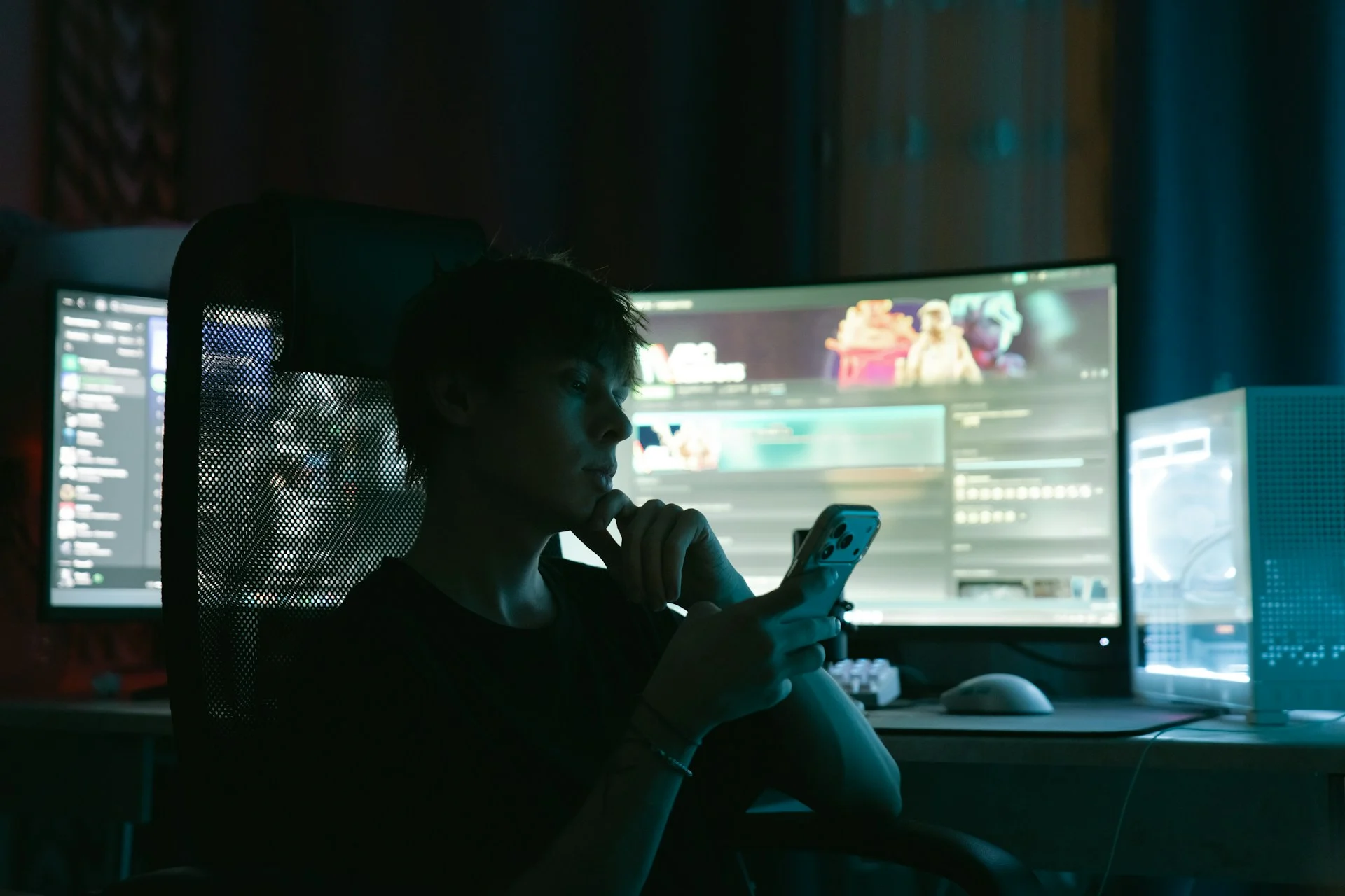 Glowing smartphone game screen in a dark room, illustrating Apple gaming on iPhone