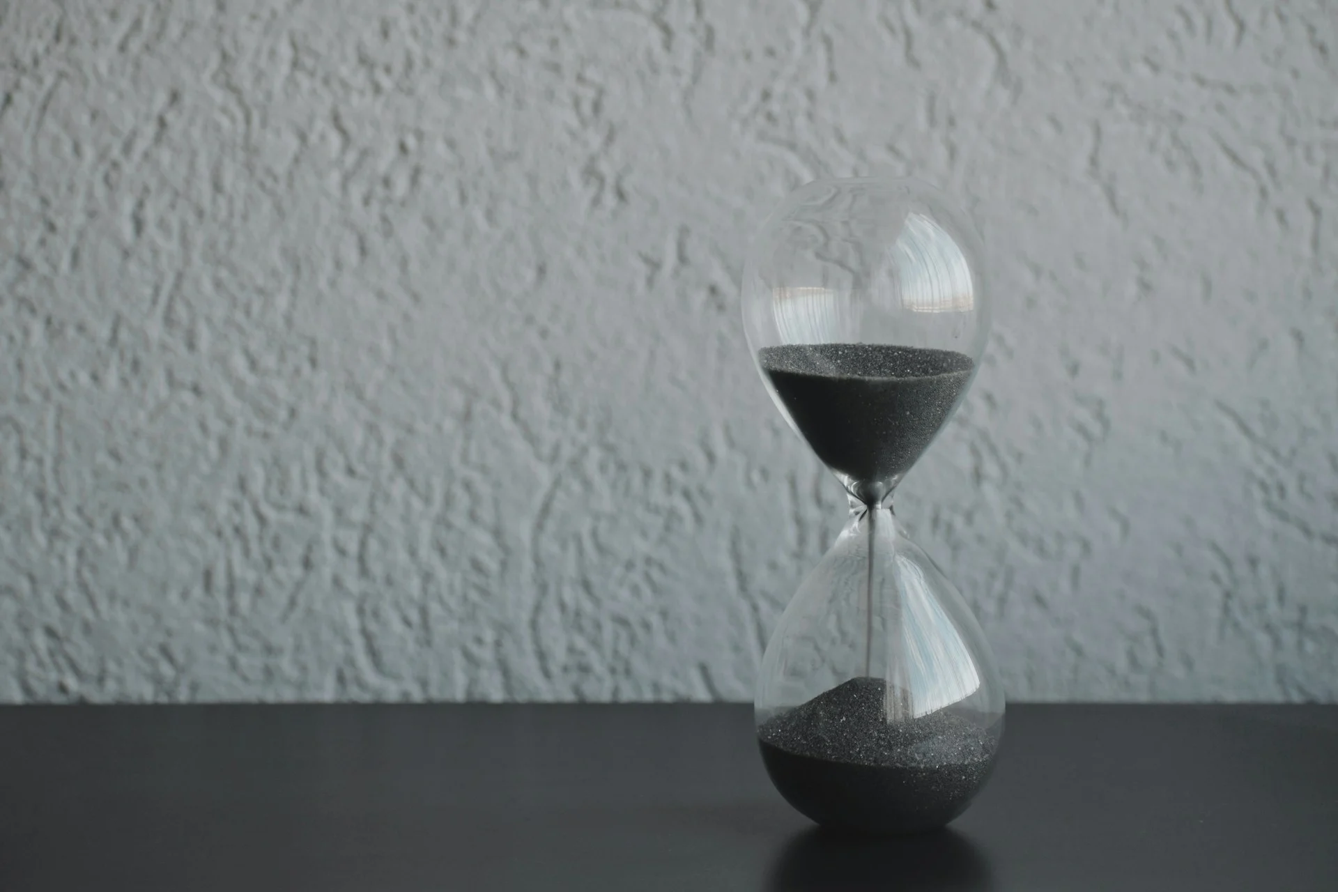 Hourglass in dramatic light symbolising ChatGPT Business limits and the Codex cooldown