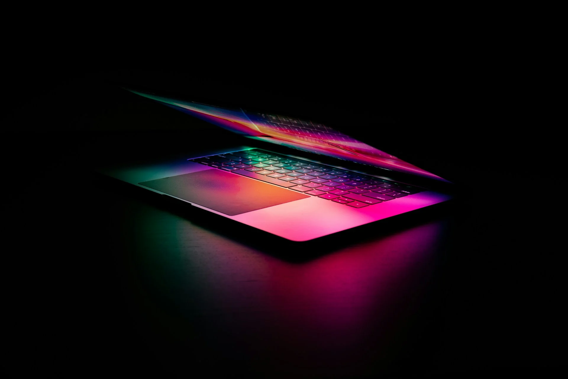 Laptop screen glowing with code in a dark room, illustrating a Copilot app session in VS Code