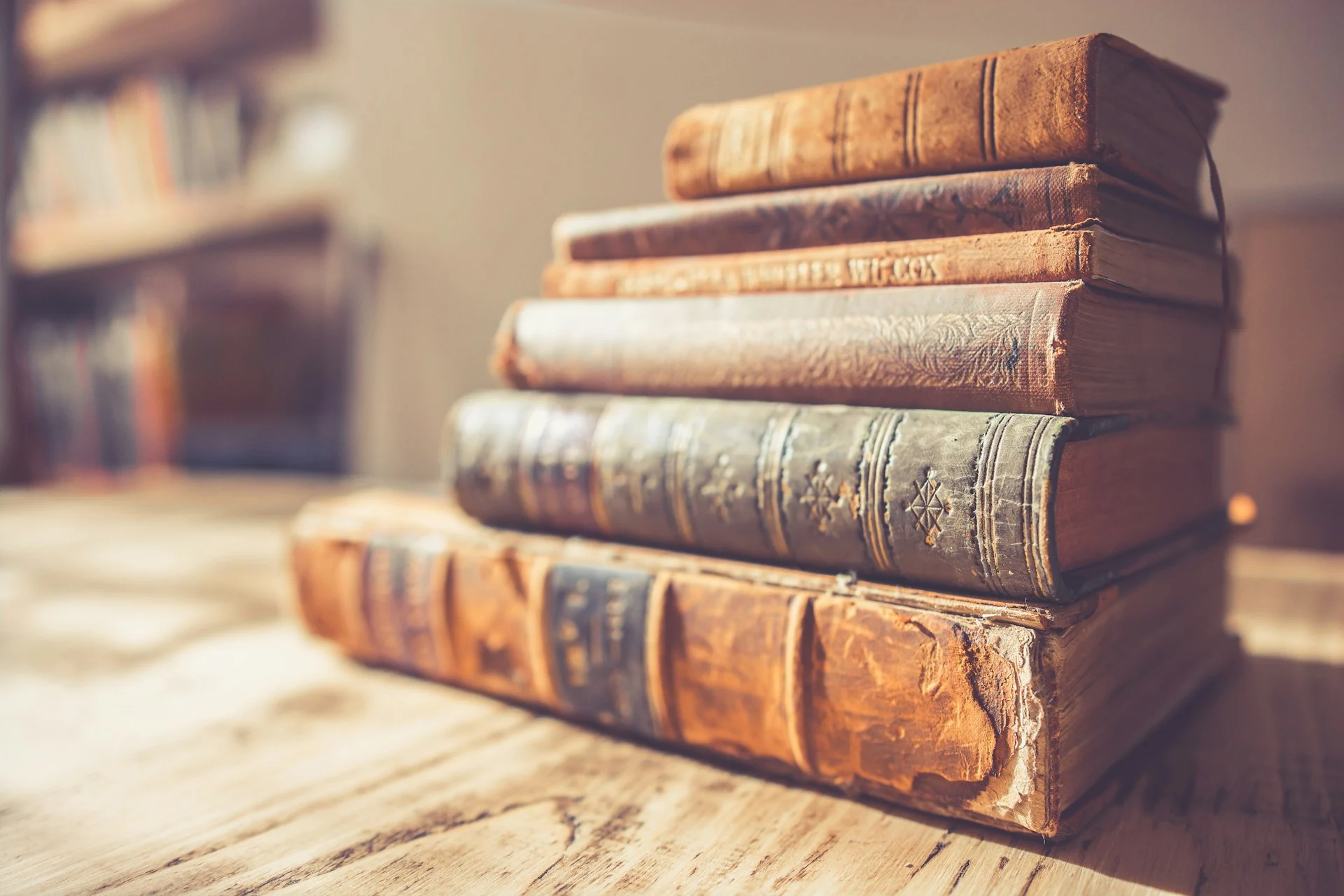 Stack of old books in dramatic light, representing the Cyberselfish reissue