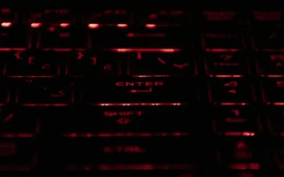 Hands on a keyboard in red light, illustrating the Docomo data leak