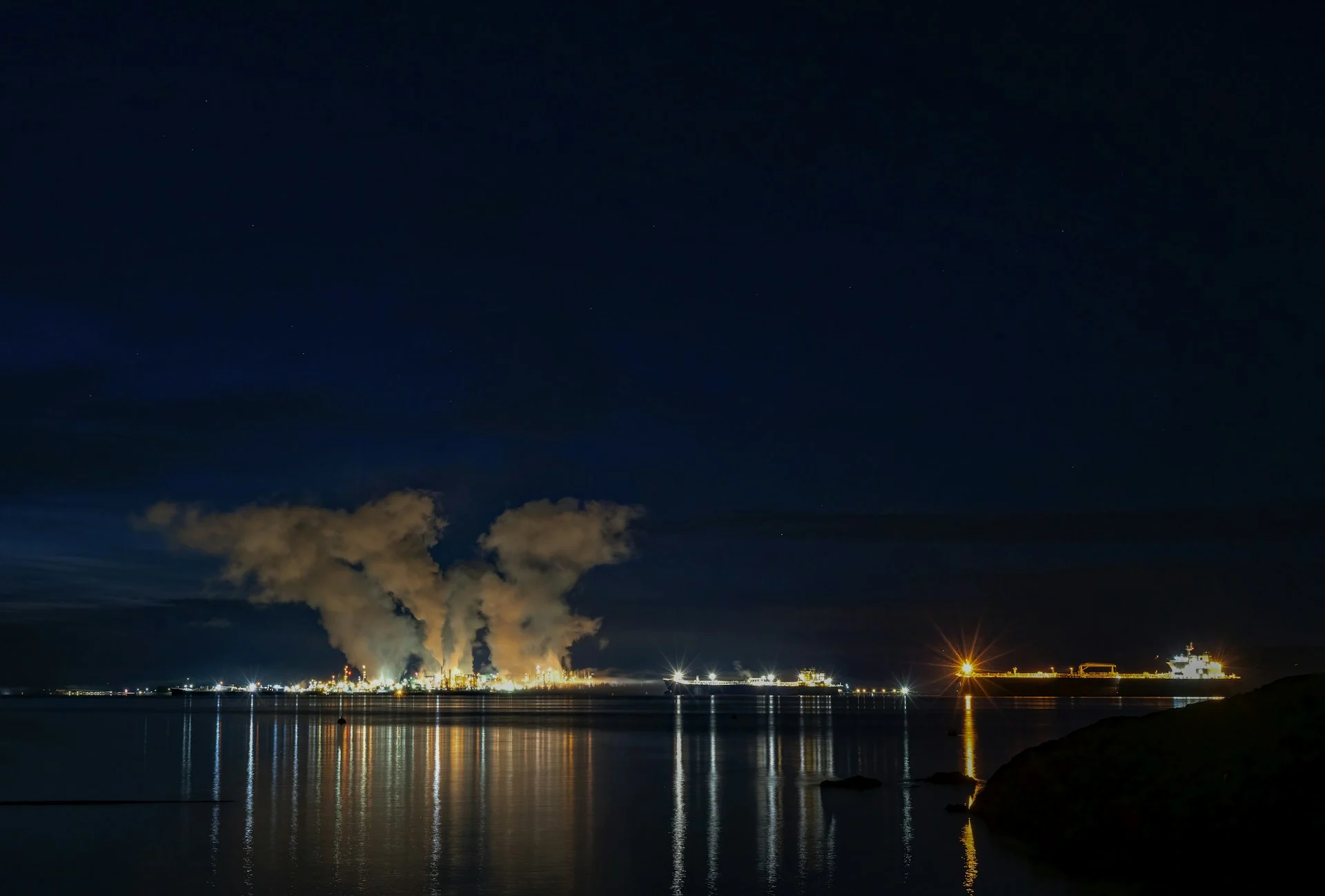 Oil refinery lit up at night as Europe diesel reserves come under pressure