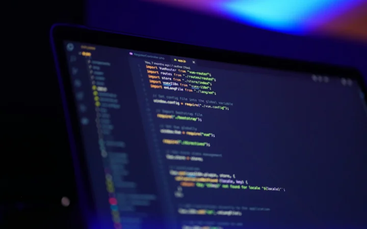 Programmer writing code on a laptop at night, as in the EVEngine AI game engine story