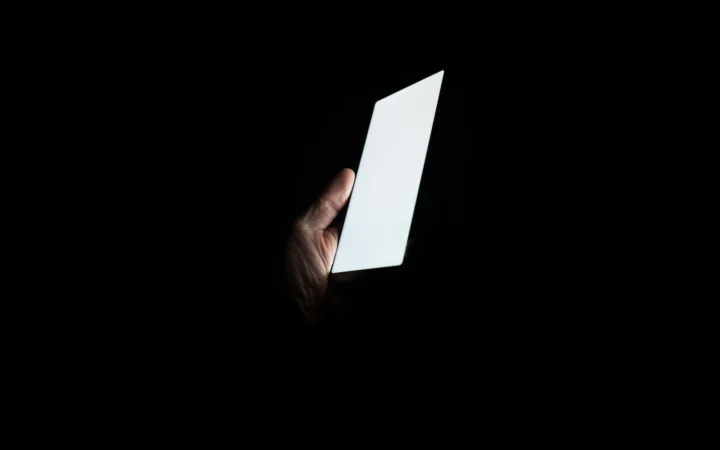 Smartphone glowing in the dark, symbolising hidden financial services in mobile apps