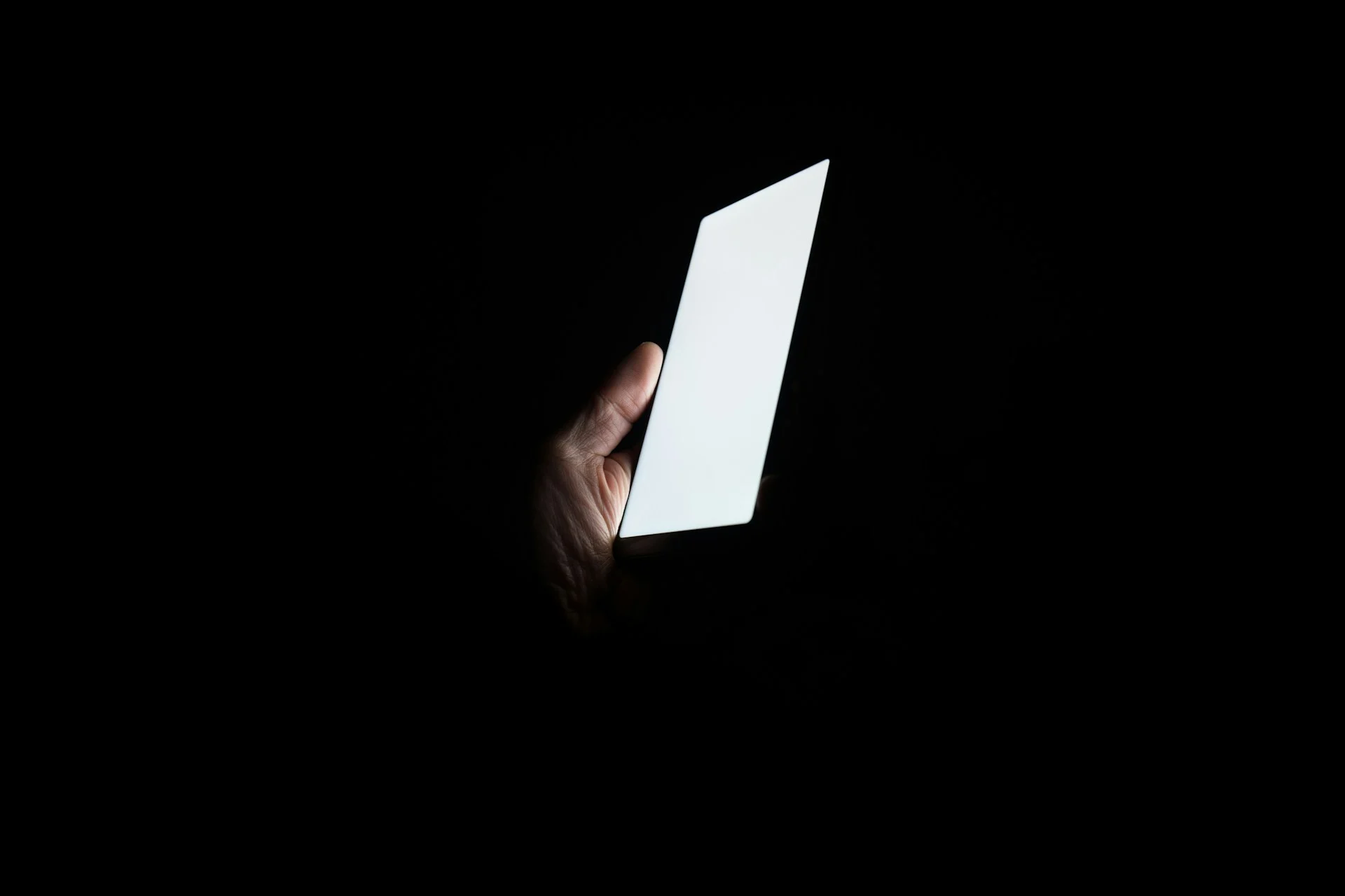 Smartphone glowing in the dark, symbolising hidden financial services in mobile apps
