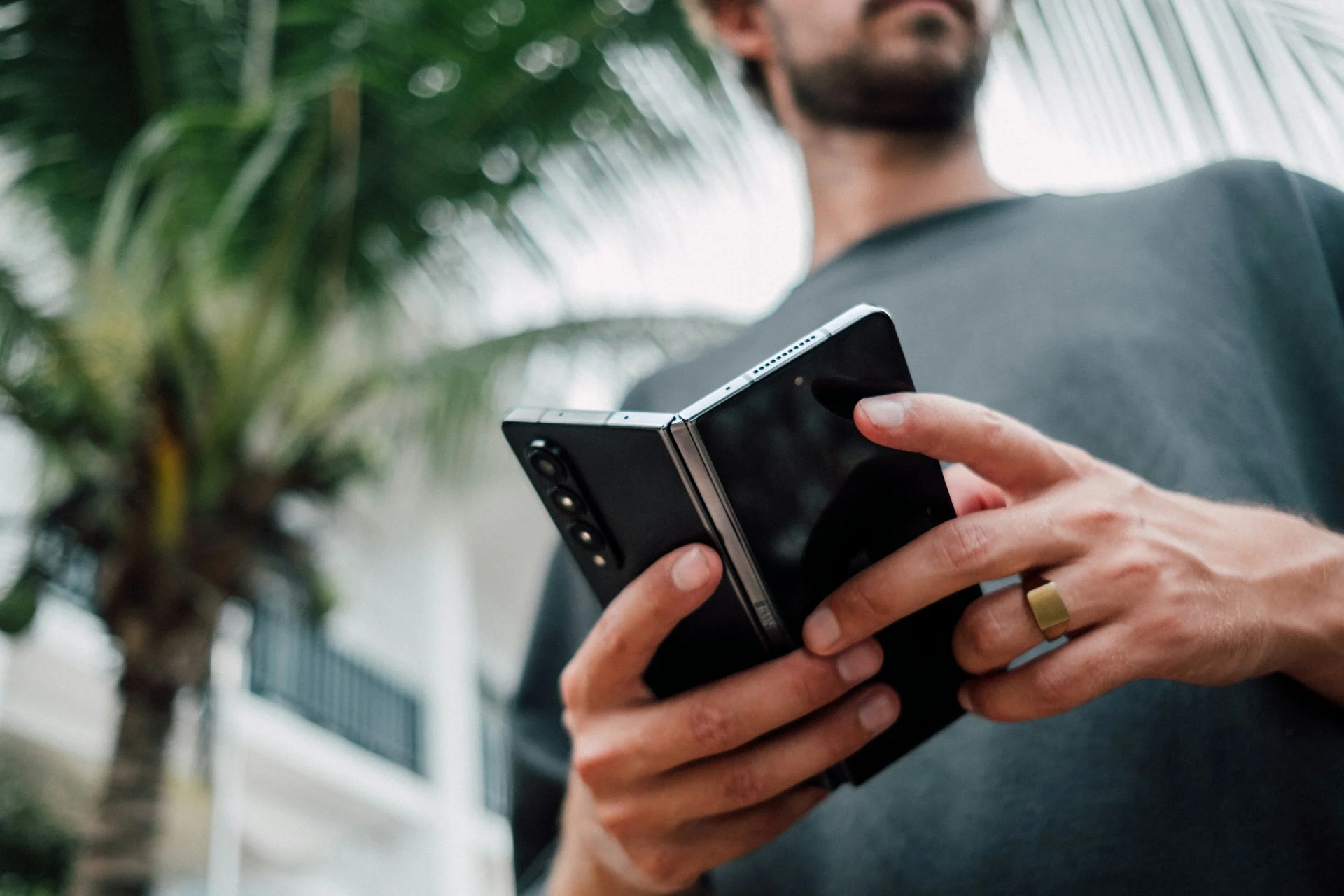 Hands holding a foldable phone half open, one of the iPhone Duo apps use cases