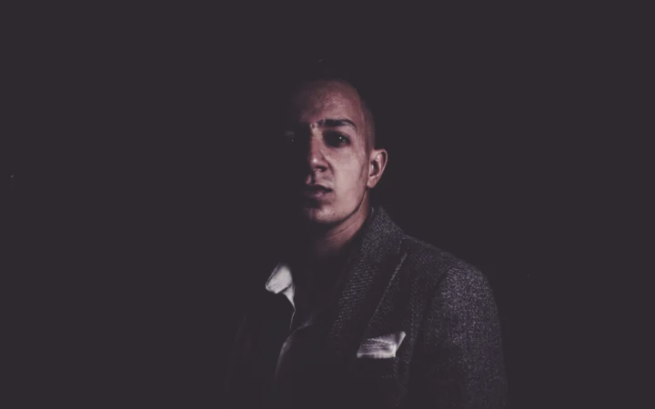 Man in a tuxedo in dramatic low light, evoking the Jack Lowden James Bond casting