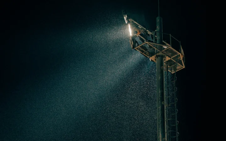 Football stadium floodlights glowing at night, evoking Jason Sudeikis's Ted Lasso