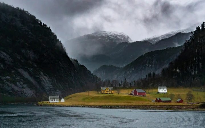 Salmon farming pens in an Icelandic-style fjord at dusk