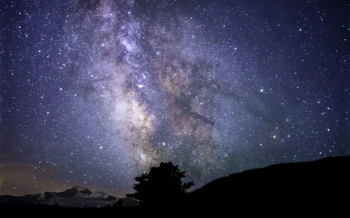 Milky Way blazing across a dark night sky, evoking the interstellar journeys of Light-Year Canon