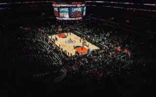 Basketball arena lit by floodlights, setting for the NBA prediction markets deal