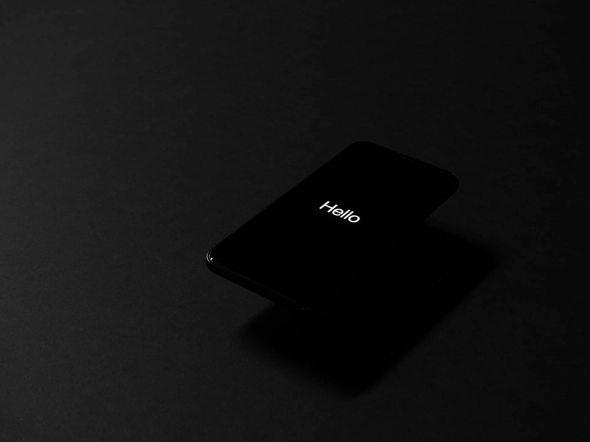Smartphone screen glowing in a dark room, illustrating teen access to nudify apps