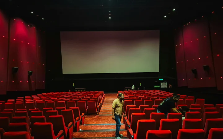 Cinema screen glowing in a dark theatre, the setting for China's first AI feature film