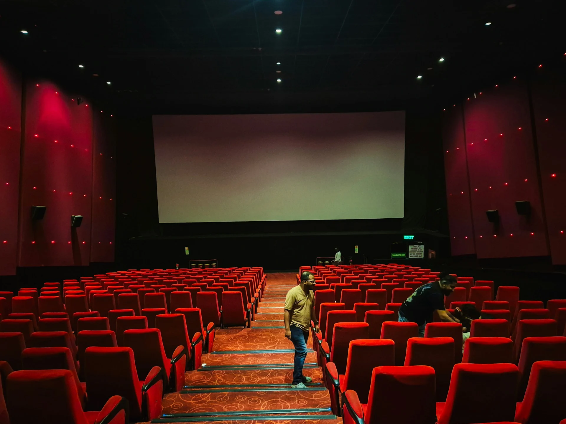 Cinema screen glowing in a dark theatre, the setting for China's first AI feature film