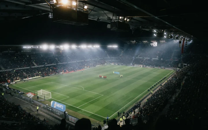 Football stadium under floodlights at night, the stage for Sauce Gardner's Colts