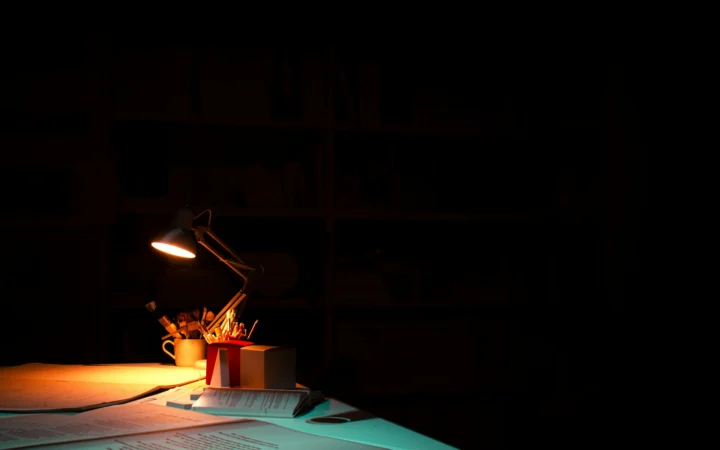 Smartphone glowing on a dark desk, the kind of device a Town AI assistant runs on