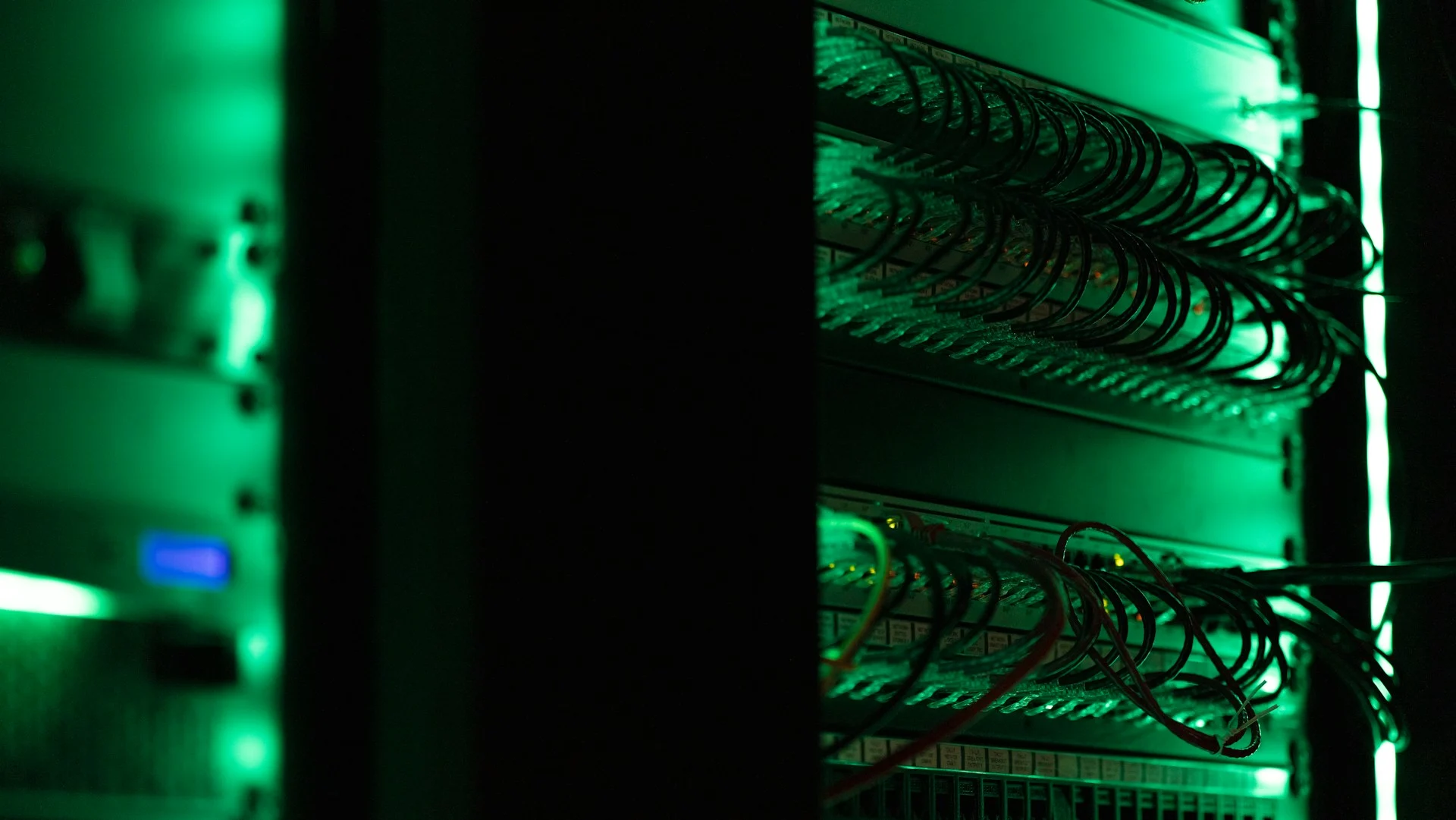 Server room corridor with blue light, representing IP and network infrastructure