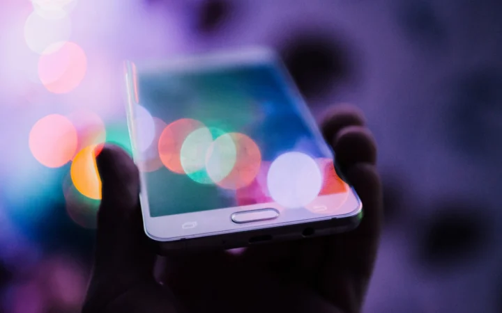 Smartphone glowing in a dark room, illustrating the WhatsApp help pages leak