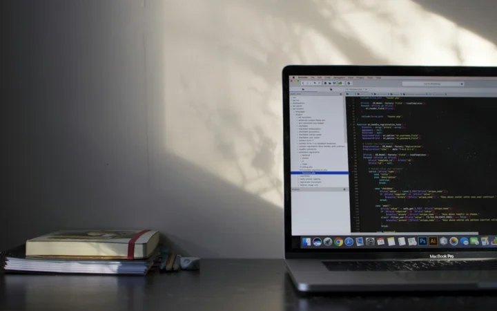 Developer laptop showing code on a dark screen